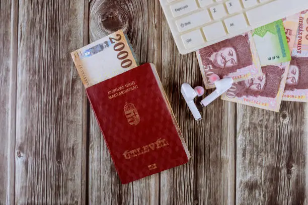 Magyar passport and computer keyboard with Hungarian forint different mixed banknotes