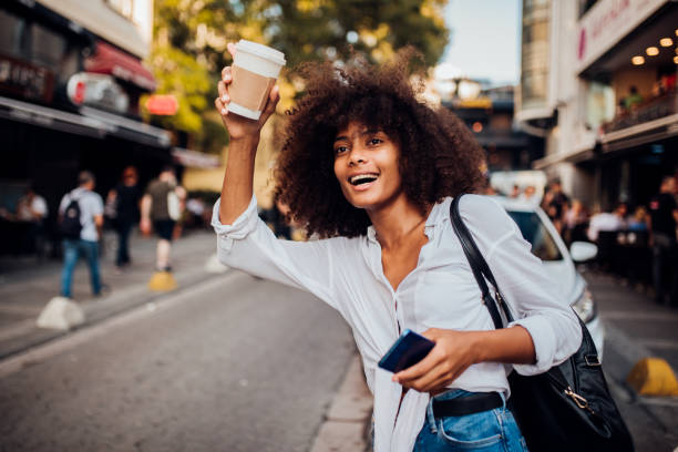 istock Beautiful Afro girl calling a cab 1187841887