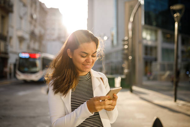 istock Happy woman using on the streets 1187842907