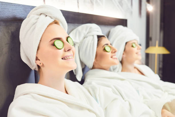 istock Young women in white bathrobe at a spa party 1187845529