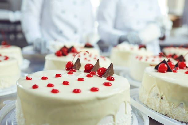 istock Red cherry on white cake on a table with cakes 1187845709