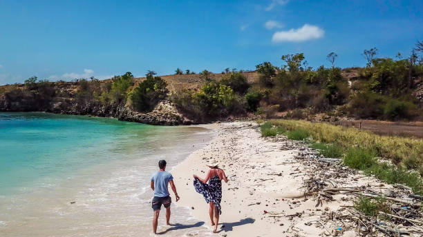 istock Lombok  - A couple walking on the beach 1187846577
