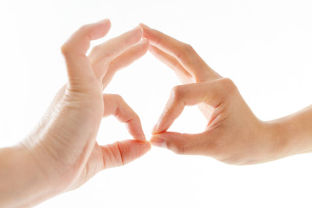 isolated hands of male teenage boy doing Hakini Yoga Mudra on a white colored background.
