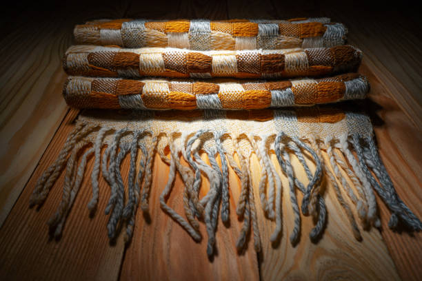 istock Stacked Knitted Blanket on a Wooden Shelf 1187848057