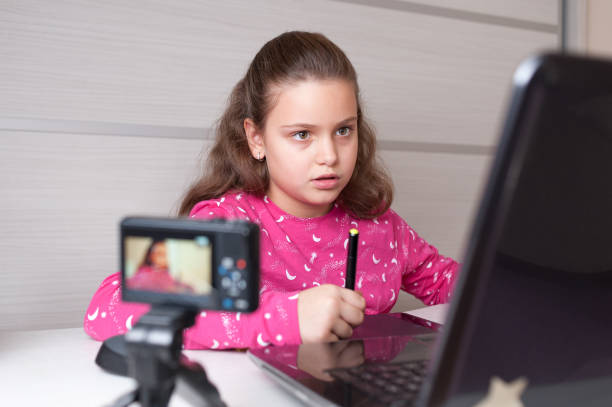istock Young digital artist girl vlogging while drawing on the graphic tablet. 1187848164