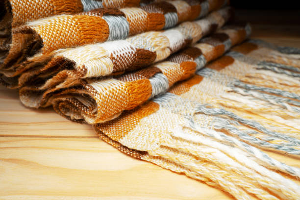 istock Stacked Knitted Blanket on a Wooden Shelf 1187848568