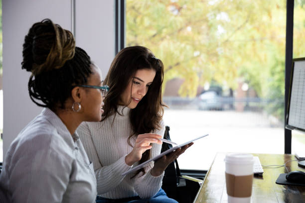istock Female employee uses digitized pen to highlight information for boss 1187848592