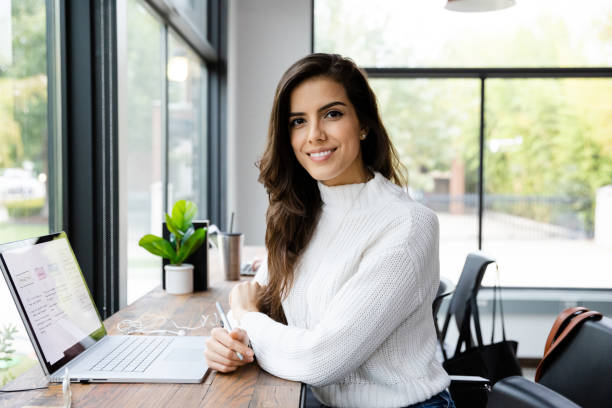 Attractive mid adult woman pauses work for photo The attractive mid adult woman pauses her work for a photo. secretary stock pictures, royalty-free photos & images