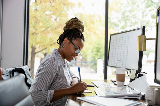 istock Business woman takes notes on reports 1187848633