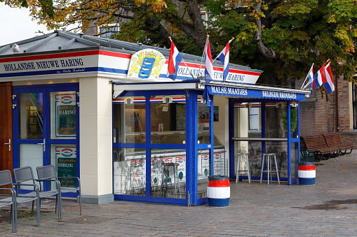 The Hague, The Netherlands - October 07, 2019: Traditional Dutch herring outdoor food kiosk. At the entrance there is no customers yet. The Hague is locally called Den Haag and is the seat of the Dutch government, but not this city but Amsterdam is the constitutional capital of the Netherlands.