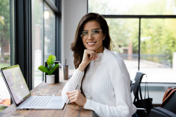 istock Mid adult female remote worker smiles for camera 1187848707