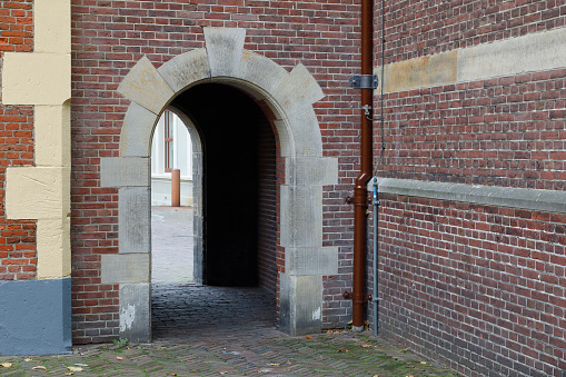 The Hague, The Netherlands - October 07, 2019: The pedestrian gate is seen from the inner courtyard of Binnenhof Palace, the buildings of the Dutch Parliament. The Hague is locally called Den Haag and is the seat of the Dutch government, but not this city but Amsterdam is the constitutional capital of the Netherlands.