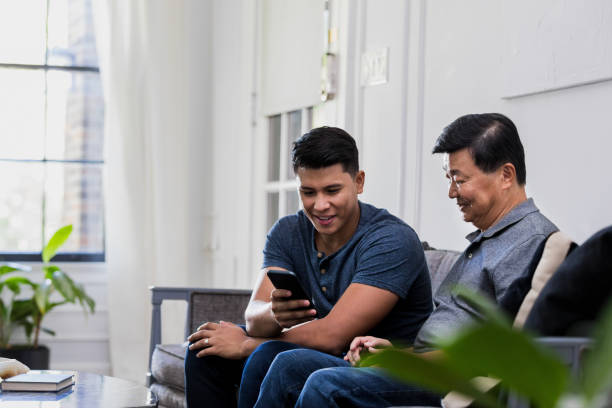 istock Son teaches senior father about mobile apps 1187848804