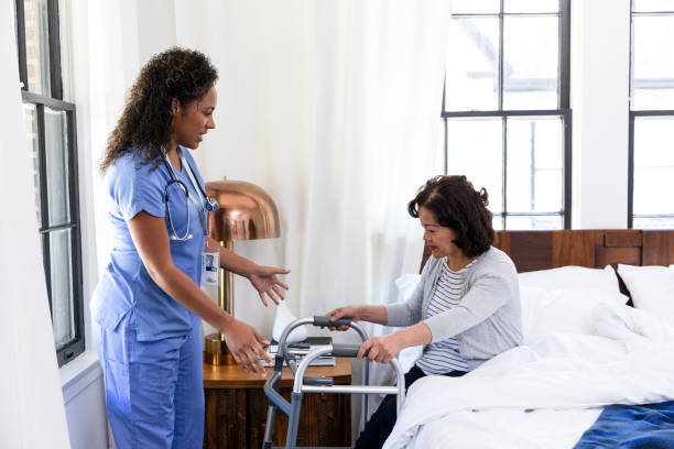 istock Nurse helps senior patient use walker 1187849009