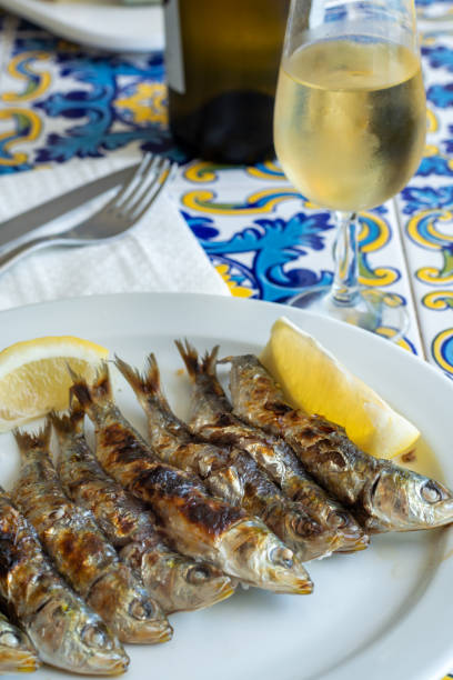 istock Espeto, Malaga style fish on stick barbecue prepared on olive tree firewoods served with dry fino sherry wine 1187852821