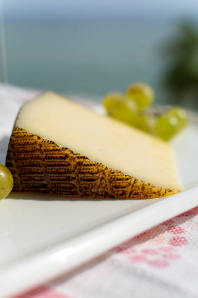 istock Spanish sheep cheese served with white grapes outside with sea view 1187852844