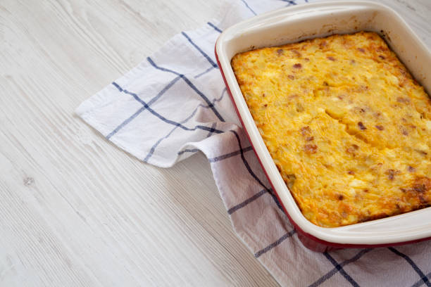istock Home-baked Cheesy Amish Breakfast Casserole on a white wooden surface, low angle view. Copy space. 1187853031