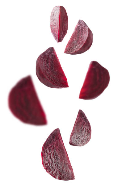 istock Flying set peeled pieces of beetroot on white. Isolated. 1187854521