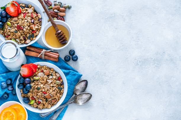 istock Healthy eating: two granola bowls with fruits for breakfast. Top view with copy space 1187854584
