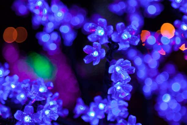 istock Decorative electrics tree bulbs blue flowers shines at night 1187855035