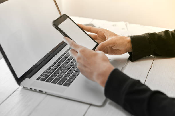 istock Young man working on his laptop with blank copy space screen for your advertising text message in office, sitting at the wooden desk 1187859861