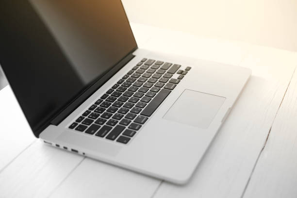 istock Young man working on his laptop with blank copy space screen for your advertising text message in office, sitting at the wooden desk 1187860838