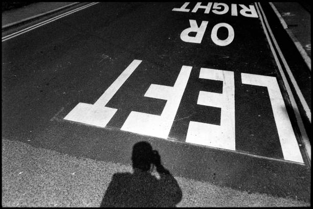 Black and white film photo, focus on words, in high contrast, converging diagonal lines emphasise perspective.