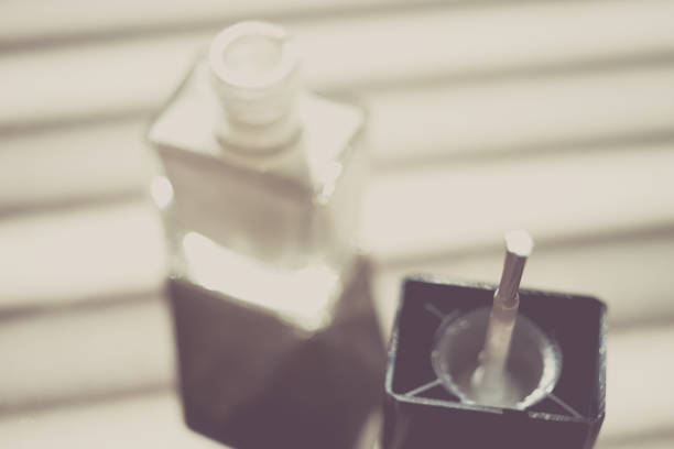 istock Unfocused opened bottle with white nail polish on a sunny table. 1187865642