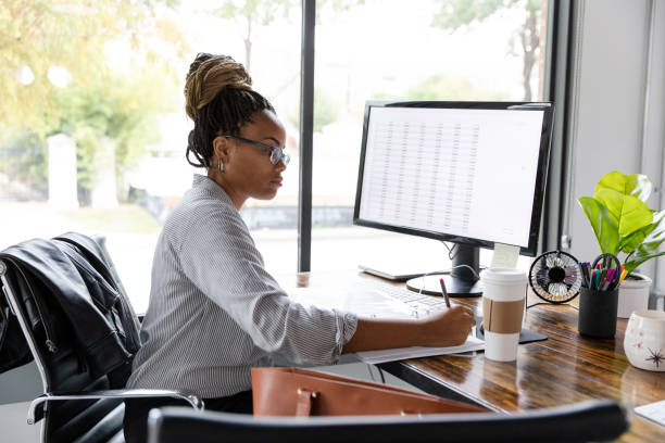 istock Busy businesswoman concentrates while working at her desk 1187865876