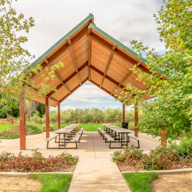 istock Square Beautiful view of a picnic pavilion at a park with pathway and trees in front 1187868040