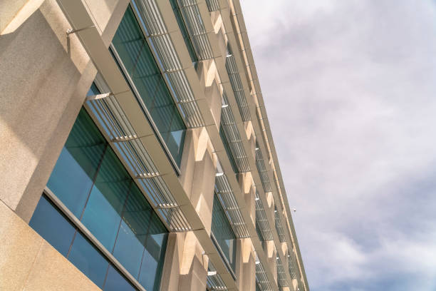 istock Modern office building exterior viewed against cloudy sky on a sunny day 1187869984