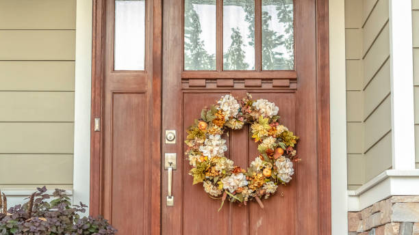 istock Panorama frame Front door with dried flower wreath day 1187870546