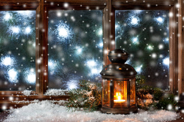 istock Winter  frost window with burning lantern, Christmas  or Advent 1187870597