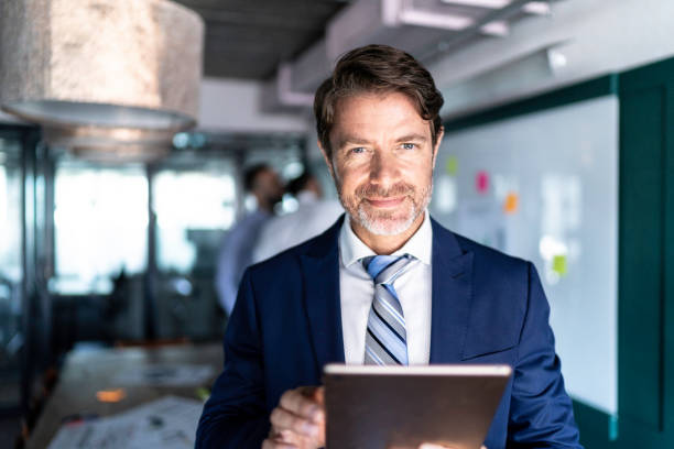 istock Portrait of a businessman using a digital tablet 1187872158