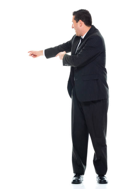 istock Side view / sideways glance / profile view / full length / front view / one man only / one person of adult handsome people caucasian male / young men presenter / manager / businessman / business person standing wearing businesswear / a suit 1187872633