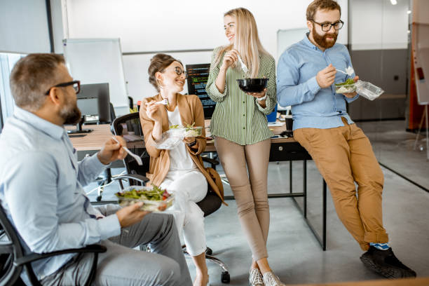 istock Colleagues eating salad in the office 1187874248