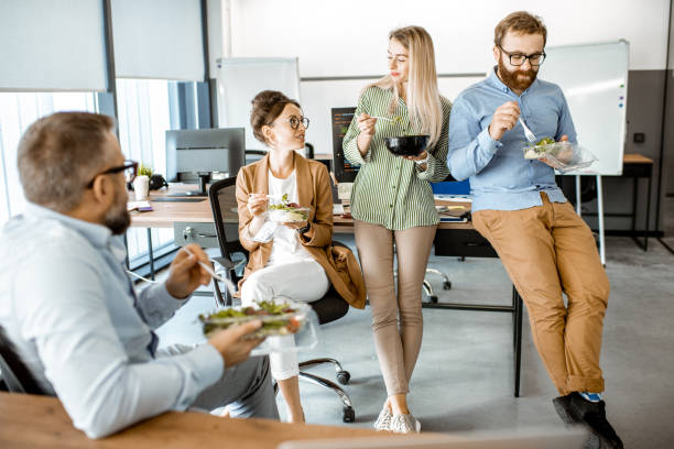 istock Colleagues eating salad in the office 1187874256