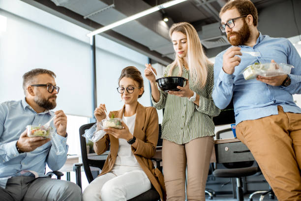 istock Colleagues eating salad in the office 1187874767