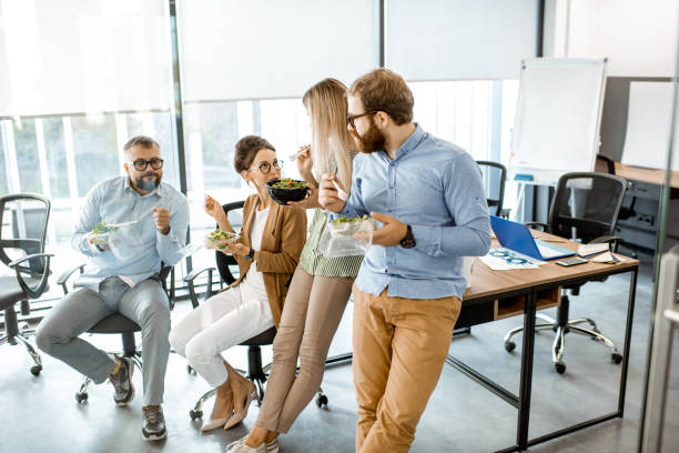 istock Colleagues eating salad in the office 1187874796