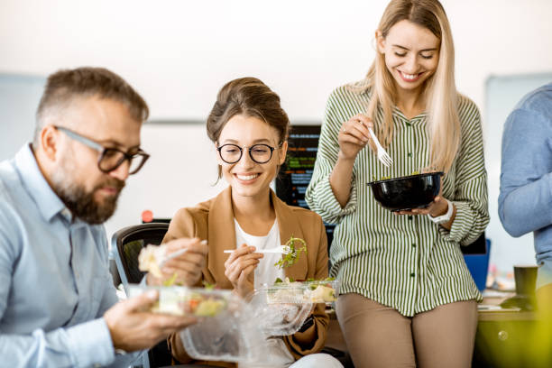 istock Colleagues eating salad in the office 1187874797