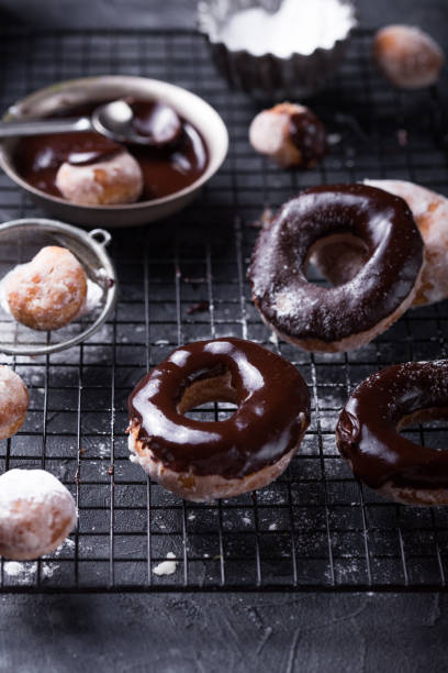 istock Homemade donuts chocolate glazed  on a stone  background. Rustic style. 1187874960