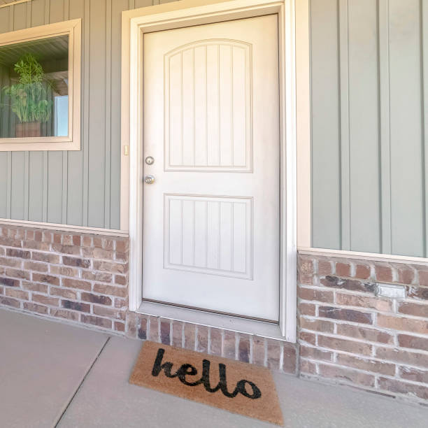 istock Square frame Front door and veranda of home with welcome mat 1187877482