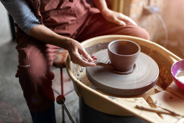 istock Elderly woman making ceramic work with potter's wheel 1187877613