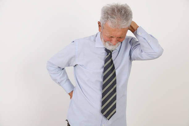 senior man with back pain , rheumatism . chiropractic / physiotherapy treatment, back pain relief concept - physical injury backache occupation working imagens e fotografias de stock