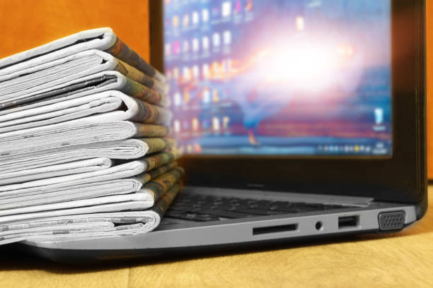 istock Newspapers and Laptop 1187880883
