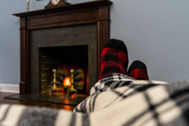 burning wood in the fireplace. the cozy atmosphere of a country house. heating the house with firewood. seasonal fireplace operation.