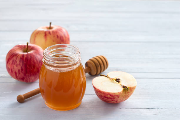 istock Apples and honey on wooden background 1187884596