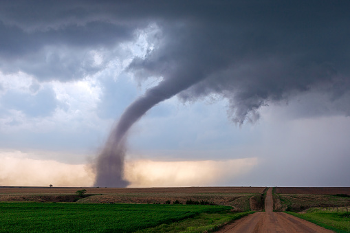 A tornado funnel spins beneath a supercell thunderstorm during a severe weather event near McCook, Nebraska.