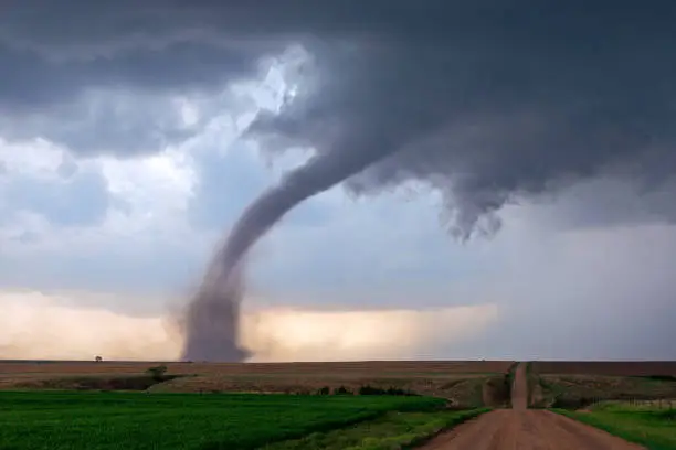 A tornado funnel spins beneath a supercell thunderstorm during a severe weather event near McCook, Nebraska.