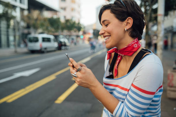 istock Beautiful young woman calling for a cab 1187887677